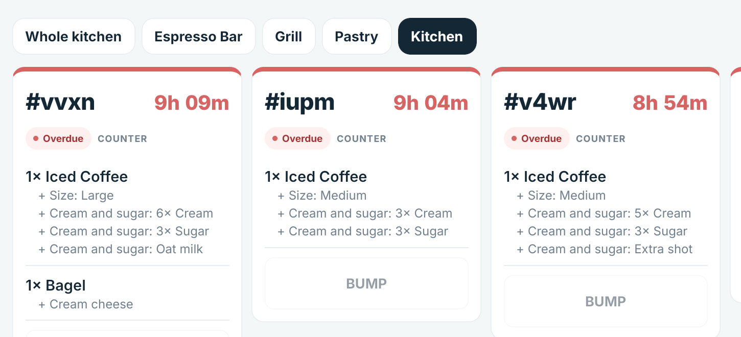 The DineStack kitchen board with tabs for the whole kitchen, espresso bar, grill and pastry, showing tickets and their modifiers.